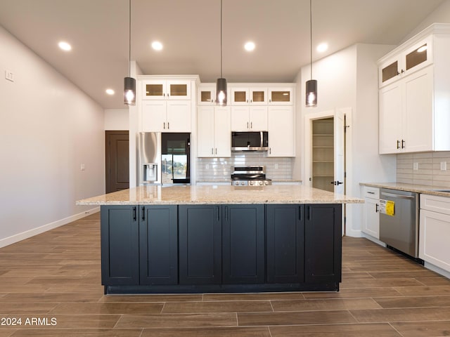 kitchen featuring pendant lighting, a center island, white cabinetry, and appliances with stainless steel finishes