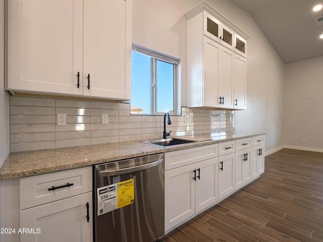 kitchen with vaulted ceiling, sink, dishwasher, dark hardwood / wood-style floors, and white cabinetry