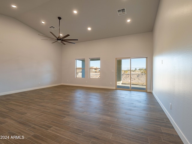 empty room with ceiling fan, high vaulted ceiling, and dark wood-type flooring