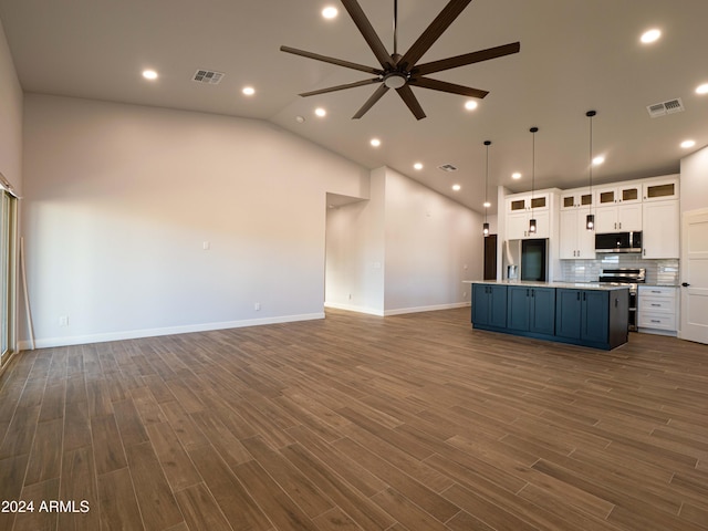 kitchen with white cabinets, dark hardwood / wood-style floors, pendant lighting, and appliances with stainless steel finishes