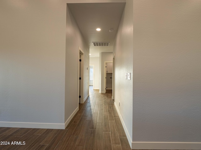 corridor featuring dark hardwood / wood-style flooring