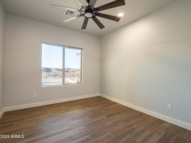 empty room featuring ceiling fan and dark wood-type flooring