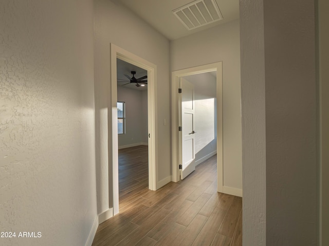 corridor with wood-type flooring