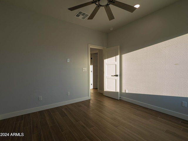 spare room with ceiling fan and dark hardwood / wood-style floors