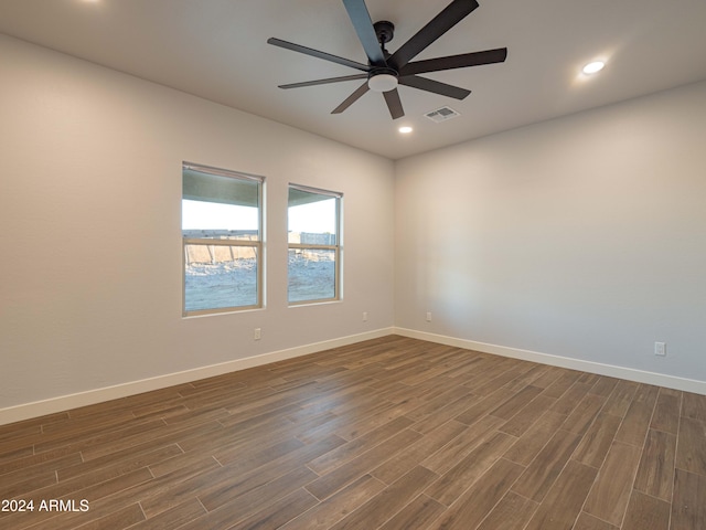 spare room with ceiling fan and dark wood-type flooring