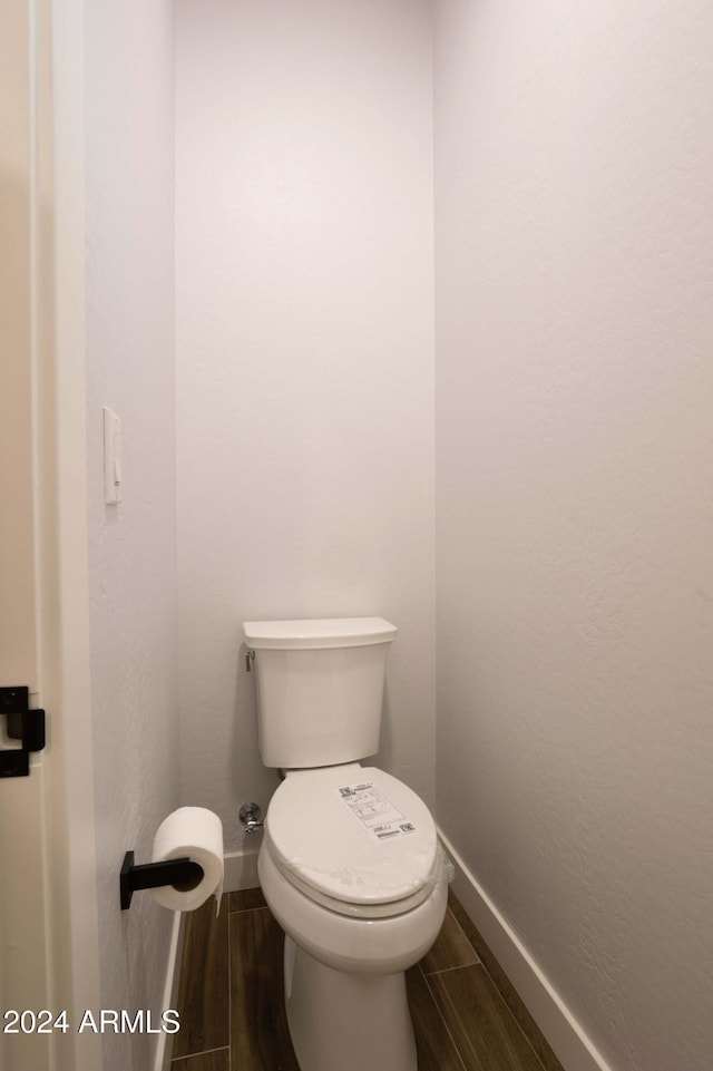 bathroom featuring hardwood / wood-style floors and toilet