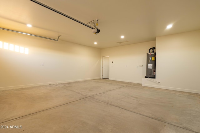 garage featuring a garage door opener and water heater