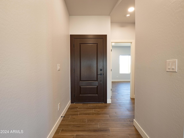 hall with dark wood-type flooring