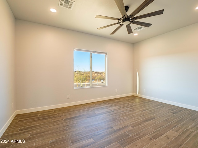 unfurnished room featuring ceiling fan and dark wood-type flooring