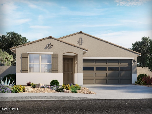 view of front of home with driveway, an attached garage, and stucco siding