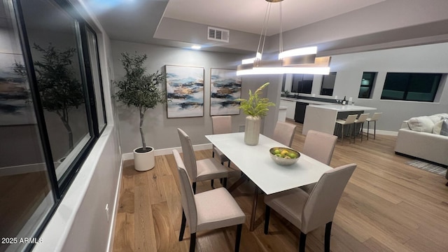 dining space with light hardwood / wood-style floors