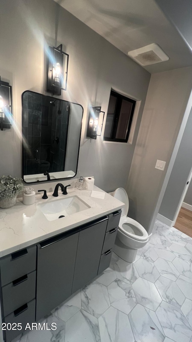 bathroom with vanity, toilet, and an enclosed shower