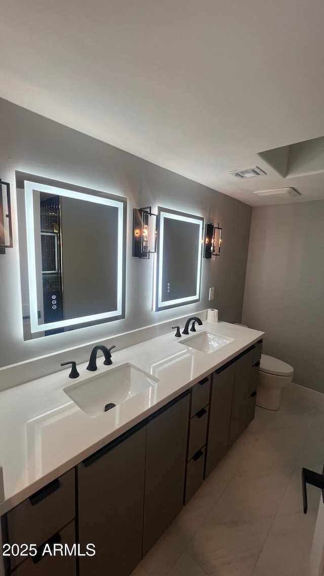 bathroom featuring vanity and toilet