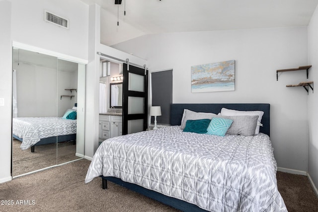 carpeted bedroom featuring visible vents, baseboards, lofted ceiling, and a closet