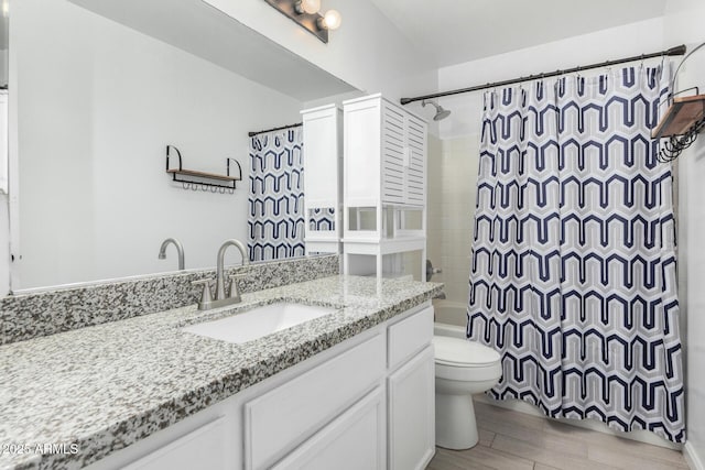 full bath featuring vanity, wood finished floors, toilet, and shower / bath combo with shower curtain