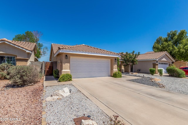 single story home featuring a gate, stucco siding, a tiled roof, and driveway