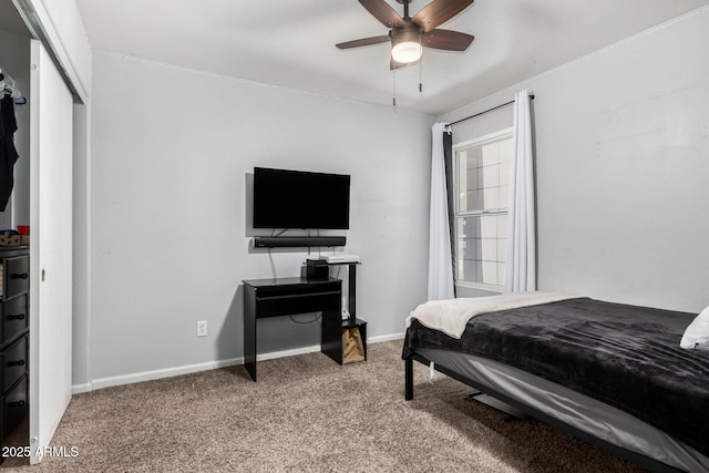 bedroom with a closet, baseboards, a ceiling fan, and carpet flooring
