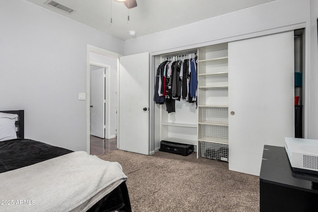 carpeted bedroom featuring visible vents, a ceiling fan, and a closet