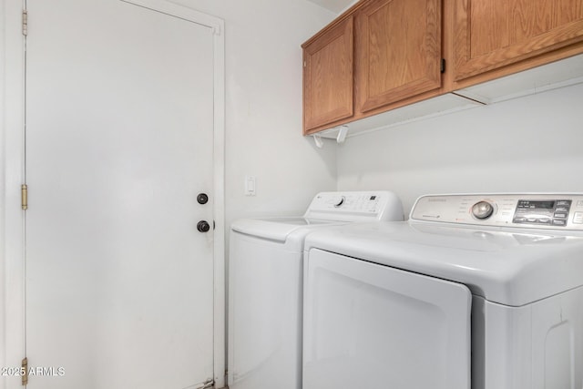 laundry area with washer and clothes dryer and cabinet space