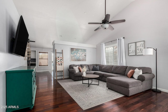 living area featuring dark wood-style flooring, a ceiling fan, vaulted ceiling, and plenty of natural light
