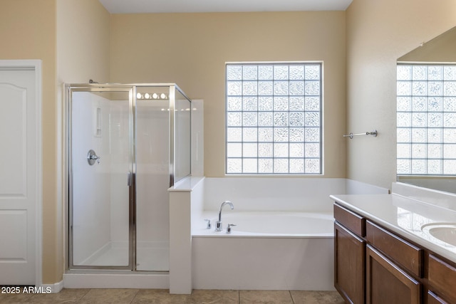 bathroom featuring shower with separate bathtub, tile patterned floors, and vanity