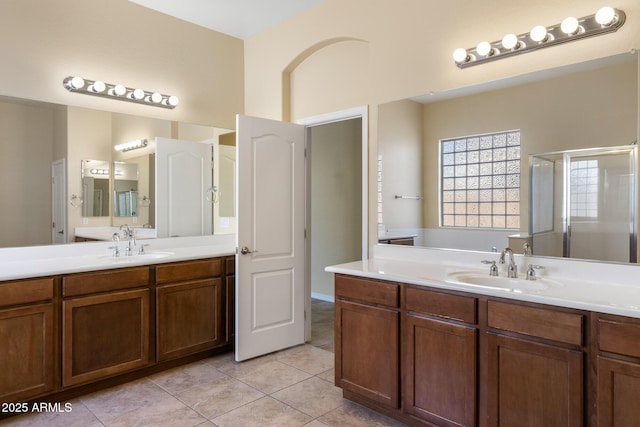 bathroom with vanity, tile patterned floors, and a shower with door