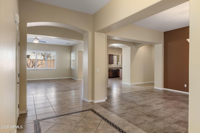 spare room featuring ceiling fan and light tile patterned floors