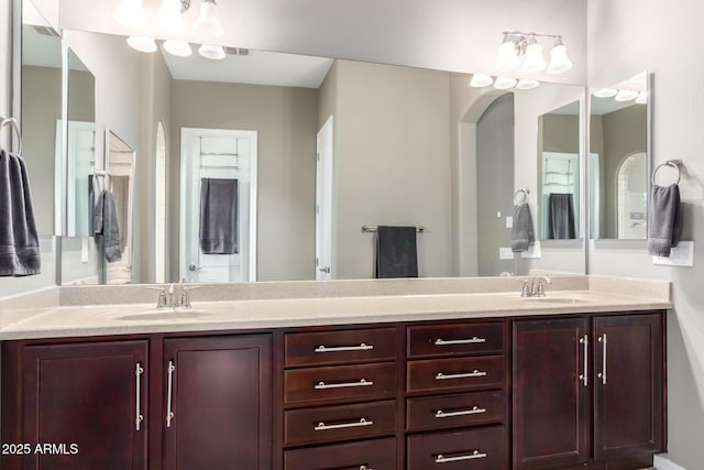 full bathroom featuring a sink and double vanity