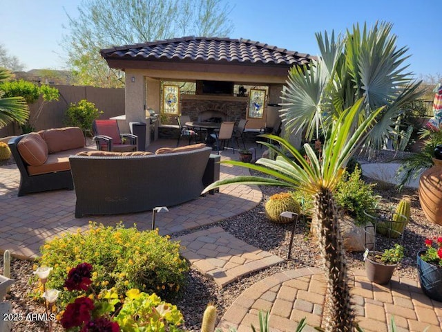 view of patio featuring an outdoor living space with a fireplace and fence