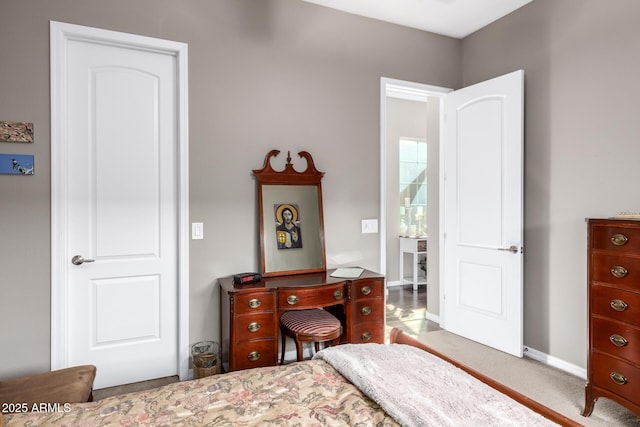 bedroom featuring carpet floors and baseboards