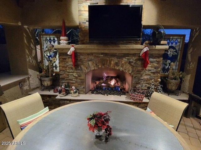 sitting room with a stone fireplace