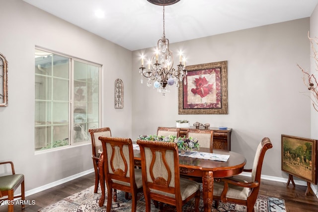 dining room with baseboards, a chandelier, and wood finished floors