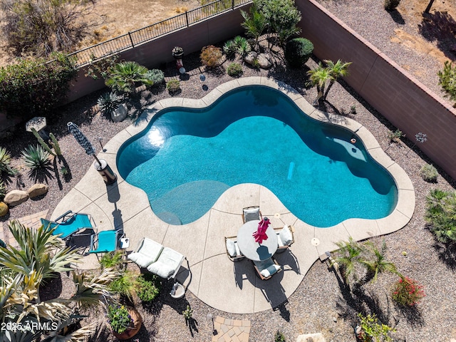 view of swimming pool with a fenced backyard