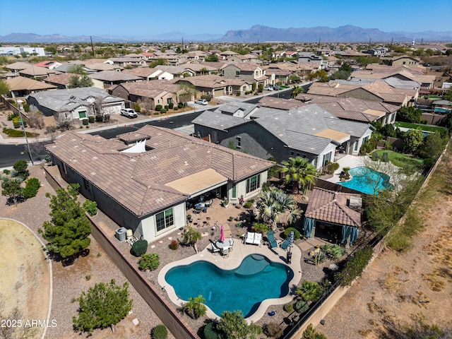 drone / aerial view featuring a residential view and a mountain view