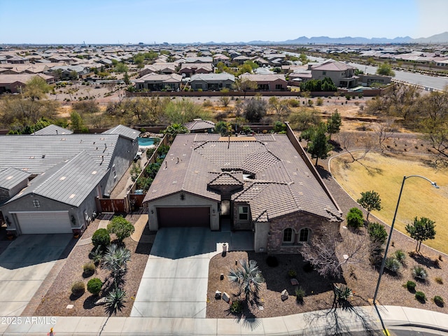 drone / aerial view featuring a residential view and a mountain view