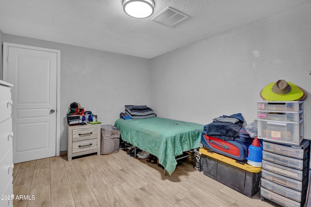 1815 E Illini St, Phoenix, AZ 85040 - bedroom featuring visible vents, wood finished floors, and a textured ceiling