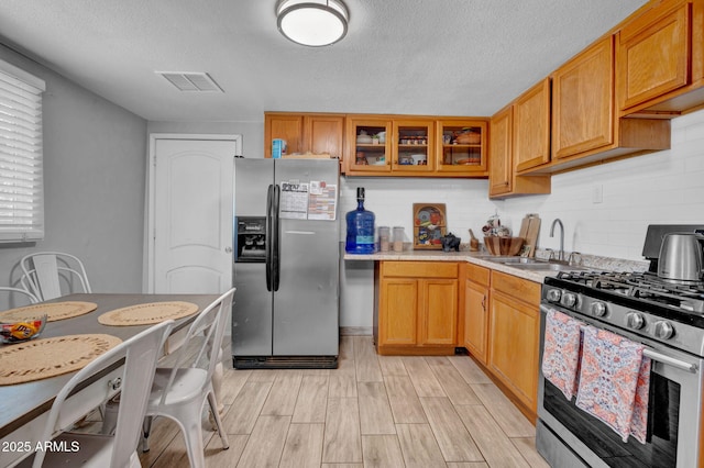 1815 E Illini St, Phoenix, AZ 85040 - kitchen featuring a sink, appliances with stainless steel finishes, decorative backsplash, and light countertops
