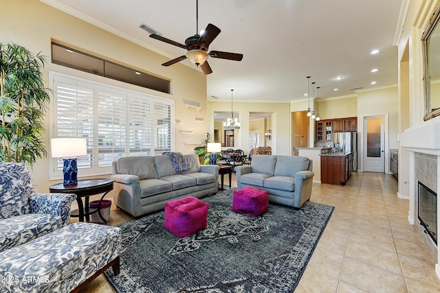 20609 N Canyon Whisper Dr, Surprise, AZ 85387 - living area with a tiled fireplace, ornamental molding, ceiling fan with notable chandelier, and light tile patterned flooring