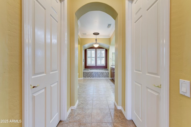 20609 N Canyon Whisper Dr, Surprise, AZ 85387 - hallway with visible vents, arched walkways, ornamental molding, a textured wall, and light tile patterned flooring