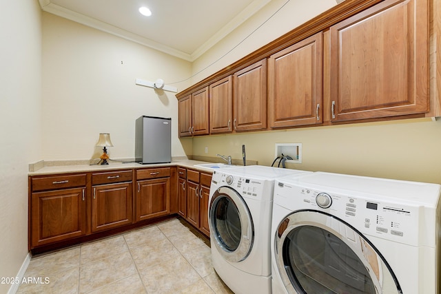 20609 N Canyon Whisper Dr, Surprise, AZ 85387 - washroom with cabinet space, a sink, light tile patterned floors, ornamental molding, and washer and clothes dryer
