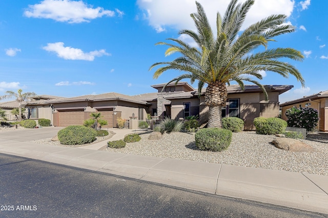20609 N Canyon Whisper Dr, Surprise, AZ 85387 - view of front facade featuring an attached garage, driveway, and stucco siding