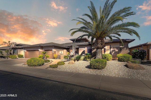 20609 N Canyon Whisper Dr, Surprise, AZ 85387 - view of front facade with a garage, stucco siding, and concrete driveway