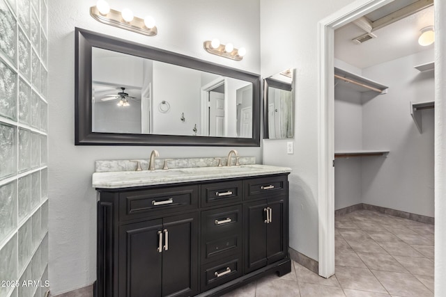 bathroom with tile patterned flooring, vanity, and ceiling fan