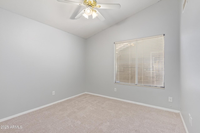 carpeted empty room featuring ceiling fan and lofted ceiling