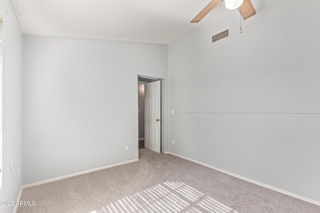 spare room with ceiling fan, lofted ceiling, and carpet