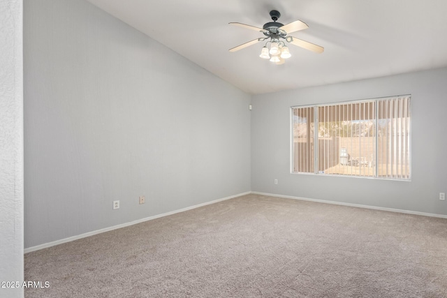 carpeted spare room with lofted ceiling and ceiling fan