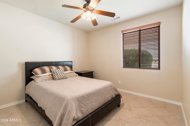 bedroom with ceiling fan and light tile patterned floors