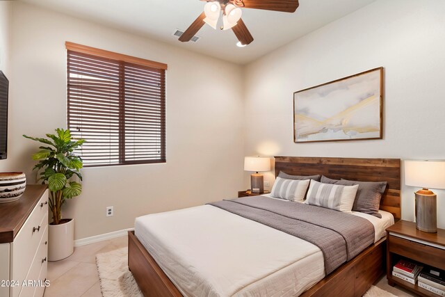 tiled empty room featuring ceiling fan