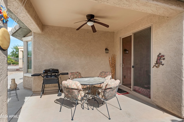 view of patio with area for grilling and ceiling fan