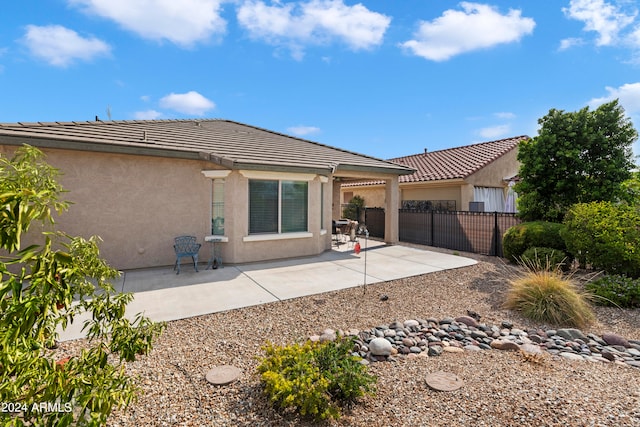 back of house with a patio